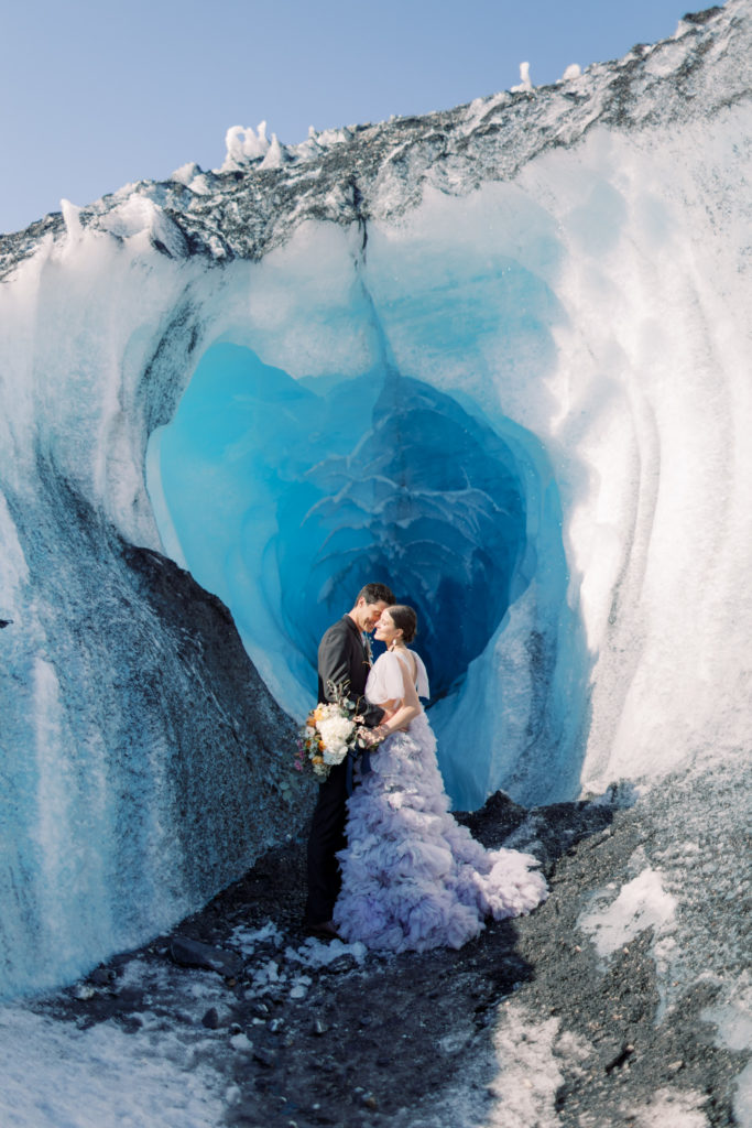 How to elope in Alaska, a couple standing on a glacier