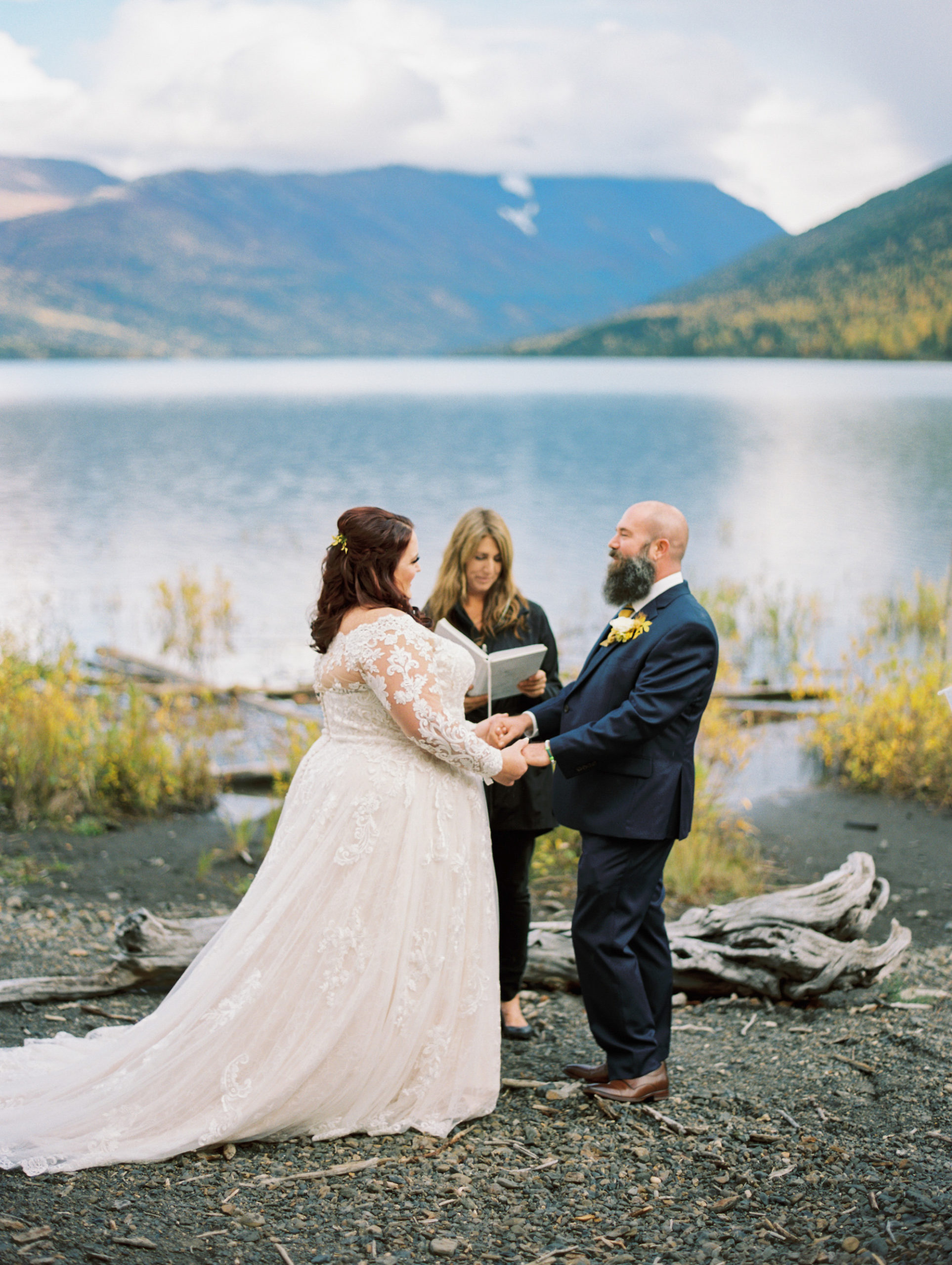 Eklutna Lake Wedding ceremony by the water, with officiant Laura Wilson from Say Yes Alaska.